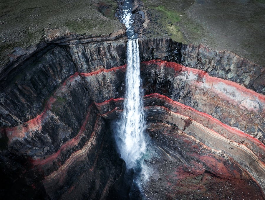 Hengifoss Waterfall and red rock formations in Iceland