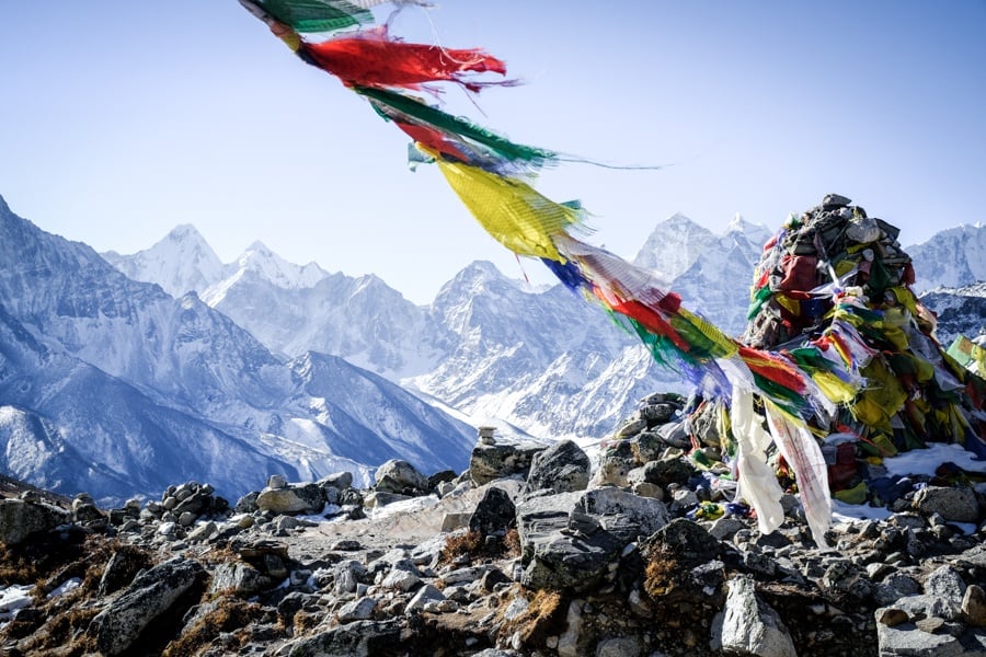 Prayer flags with white Nepal mountains in the distance at the EBC trek