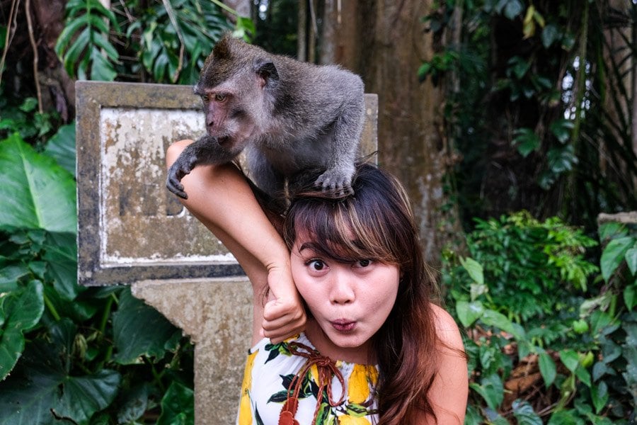 Girl holding a Bali monkey